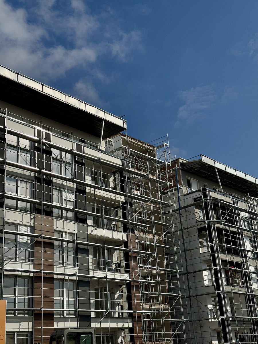 A building under construction clad in scaffolding